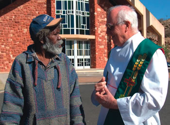 Fr Jim Knight talks with a Parishoner in Central Australia
